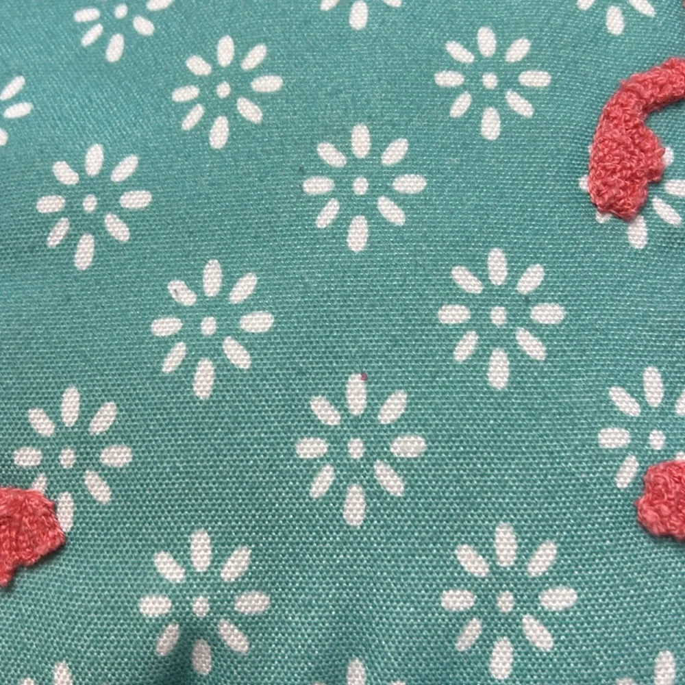 Aqua fabric pillow with hook and loop flamingo decoration.